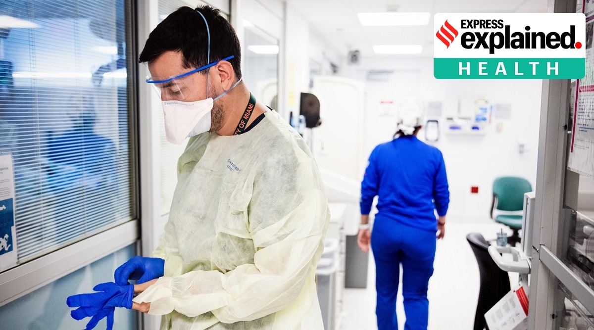 A doctor applies personal protective equipment before checking on a patient with Covid-19 at a hospital in Miami. (Scott McIntyre/The New York Times)