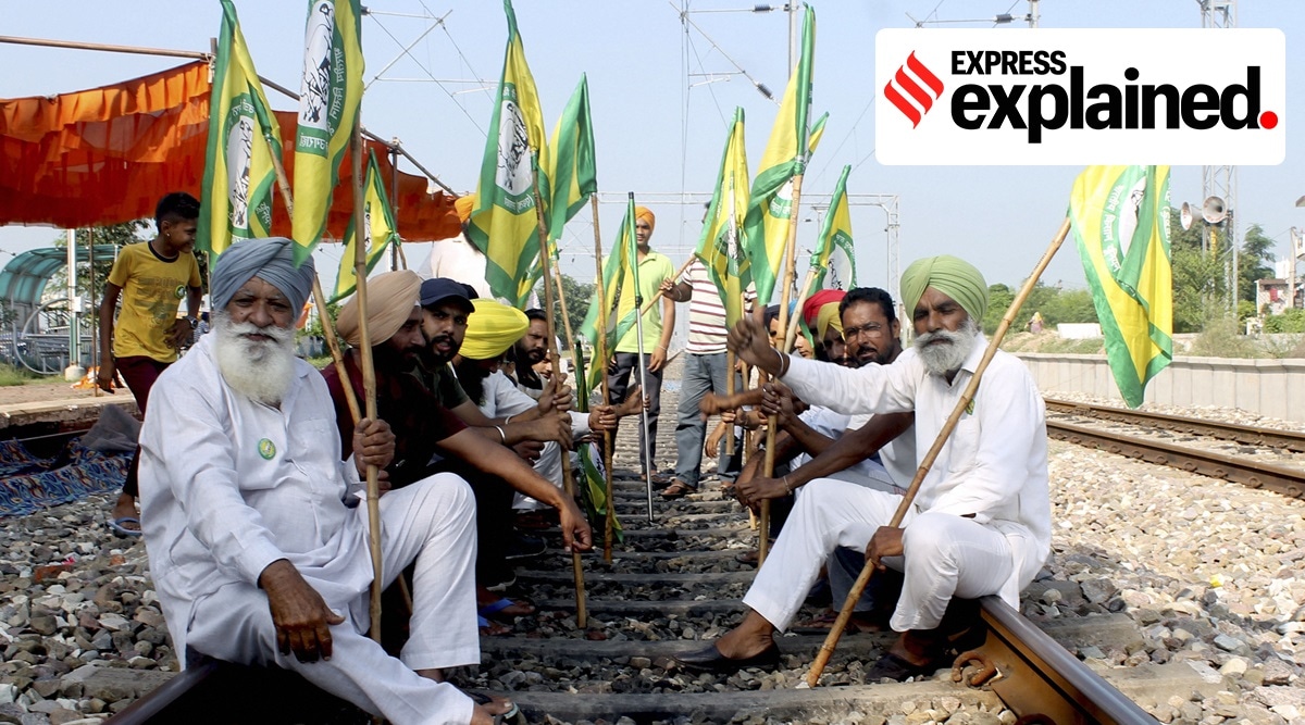 Members of Bhartya Kisan Union Ugrahan block the railway tracks during farmers' Bharat Bandh strike, at Dhablaan village near Patiala, Monday, Sept. 27, 2021. (PTI Photo)