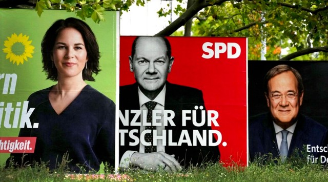In This Thursday, Sept. 16, 2021 file photo, three elections posters show top candidate for chancellor of the Greens Annalena Baerbock, left, Social Democratic top candidate for chancellor Olaf Scholz, center, and Christian Democratic top candidate for chancellor Armin Laschet, right, in Berlin, Germany. (AP)