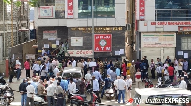 Customers gathered in front of the Sri Guru Raghavendra Sahakara Bank in Nettakallappa circle, Basavanagudi, Bengaluru (Express Photo: Darshan Devaiah BP/File)
