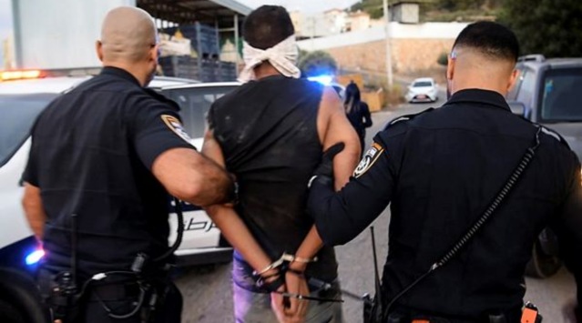 Israeli policemen arrest Palestinian militant Zakaria Zubeidi following his escape from Gilboa prison together with other five Palestinians militants, in the Israeli village of Umm Al Ghanam, Israel September 11, 2021. (Via Reuters)