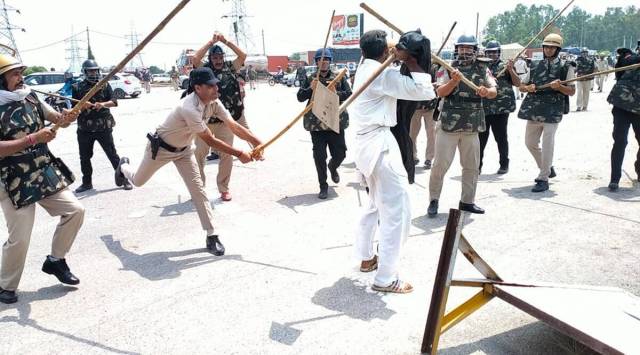 Police personnel lathicharge protesters in Karnal. (Express Photo)