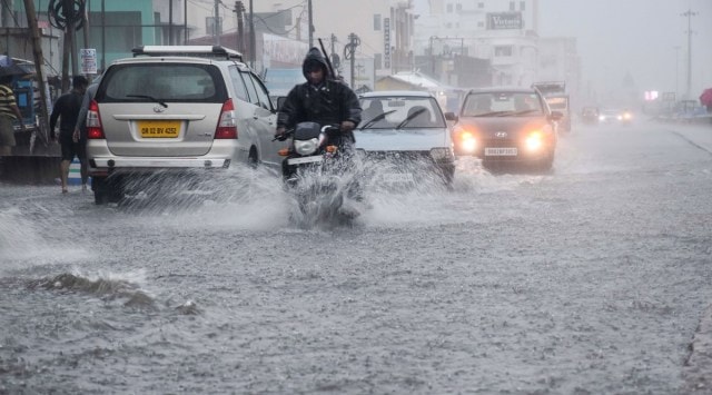 Vehicles wade through a waterlogged road in Puri on Sunday. (Photo: PTI)