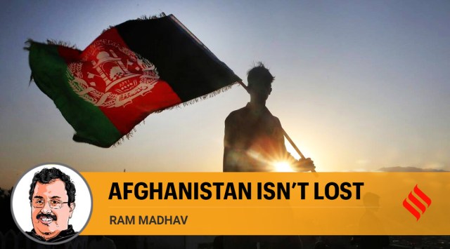 A man waves an Afghan flag in Kabul, Afghanistan. (AP)