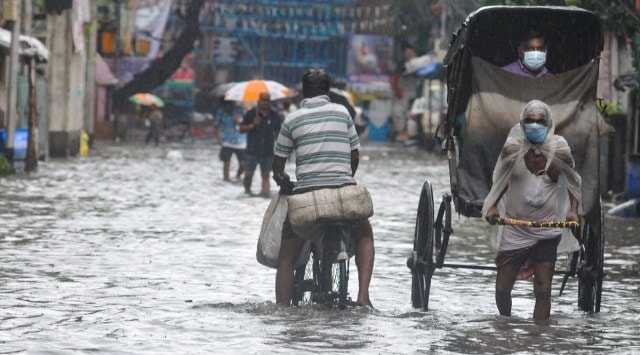 People wade through a water logged road after overnight heavy rains, in Kolkata, Wednesday, Sept. 29, 2021. (PTI)