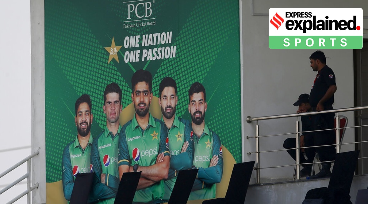 Pakistani police officers observes area next to portraits of Pakistani cricketer from an enclosure of the Pindi Cricket Stadium before the stat of the first one day international cricket match between Pakistan and New Zealand at the Pindi Cricket Stadium, in Rawalpindi, Pakistan, Friday, Sept. 17, 2021. (AP Photo)