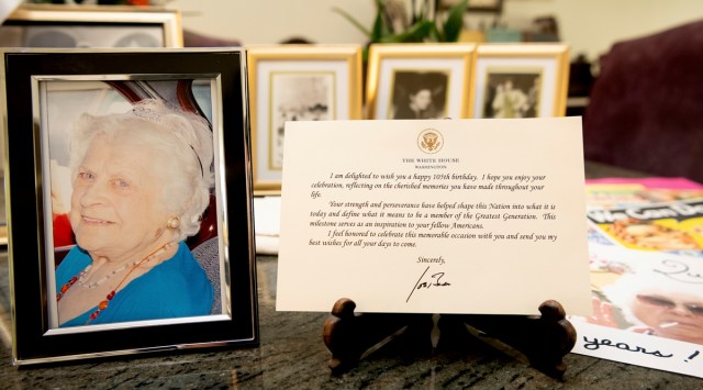 A note from President Joe Biden is seen placed among photos of Primetta Giacopini, who died of COVID-19 11 days prior in Richmond, Calif. on Monday, Sept 27, 2021. (AP)