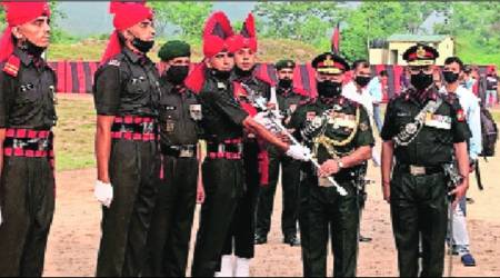 Lt General M K Das awards the Sher-e-Kashmir Sword of Honour to Peer Sartaj Ahmed Wani, at Dansal in Jammu on Saturday. (Express)