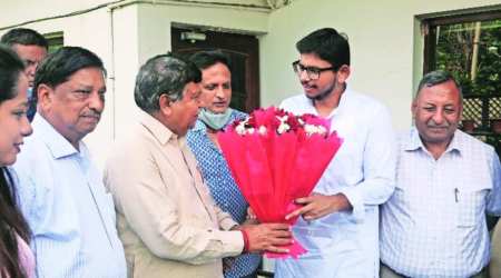 Haryana Vidhan Sabha Speaker and local MLA Gian Chand Gupta congratulates Ayush Gupta at his residence in Sector 7 of Panchkula on Saturday. (Express photo/ Jagpal Singh) 