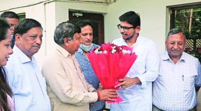 Haryana Vidhan Sabha Speaker and local MLA Gian Chand Gupta congratulates Ayush Gupta at his residence in Sector 7 of Panchkula on Saturday. (Express photo/ Jagpal Singh) 