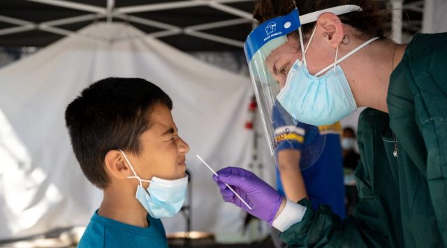 Angel Rivera is swabbed for a COVID-19 test by a health care worker at a community vaccination and testing site in the Mission District of San Francisco, Aug. 1, 2021. (NYT)