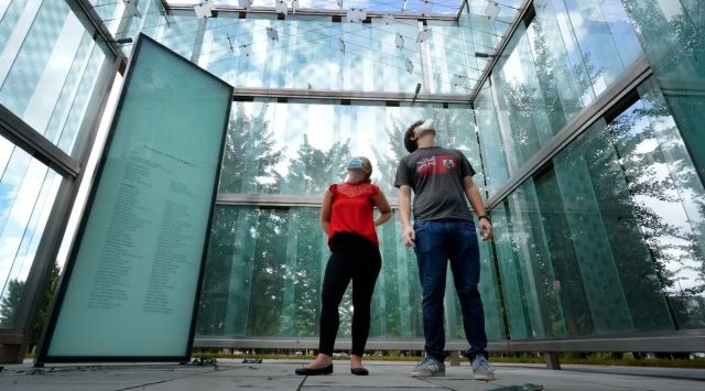 Chloe Taub and Anthony Brobenzano, of Hollywood, Florida, look at the 9/11 memorial at Logan International Airport, Thursday, in Boston. The two were the only visitors during a three-hour span that afternoon.  (AP Photo/Elise Amendola)