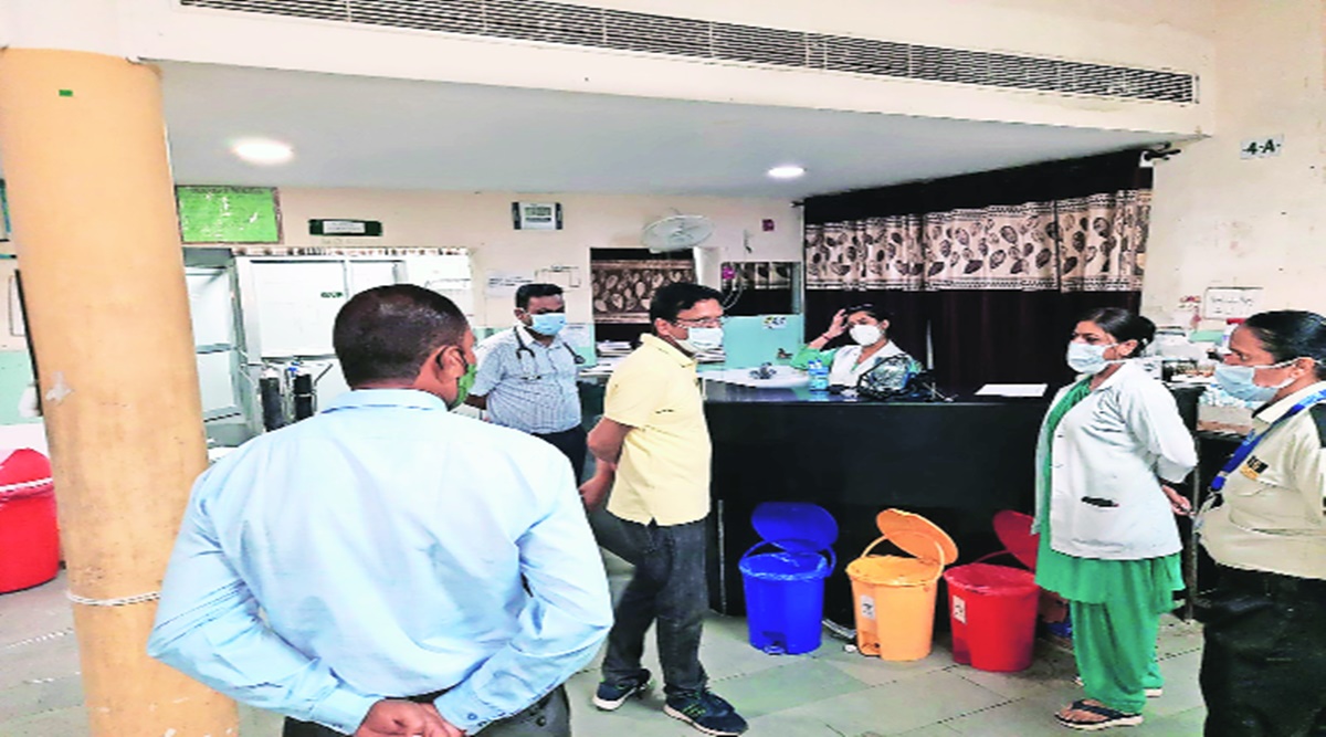 Health Secretary Yashpal Garg (in yellow t-shirt) interacting with night staff at one health institute on Sunday night.  (Express photo)