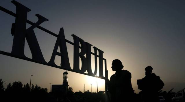 Taliban soldiers stand in front of a sign at the international airport in Kabul, Afghanistan on Sept. 9, 2021. (West Asia News Agency via Reuters)