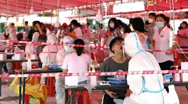Medical workers conduct nucleic acid tests for residents, following new cases of the coronavirus disease (COVDI-19), at a testing site inside a culture and art centre in Xiamen, Fujian province, China September 14, 2021. (Via Reuters)