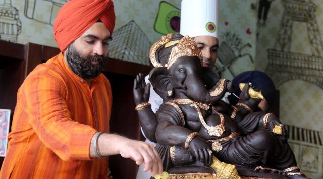 On the third day three of Ganeshotsav, the idol is immersed in milk, with the end result being nearly 45 litres of chocolate milk.  (Express Photo by Gurmeet Singh)
