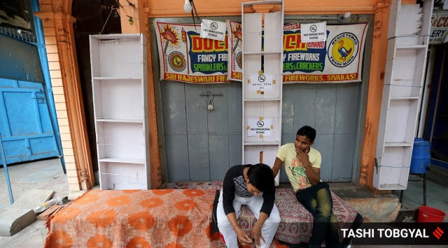 Stall owners selling firecrackers outside their closed shop due to the ban in Delhi NCR. (Express Photo: Tashi Tobgyal, File)