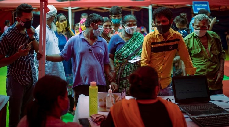 People wait to register themselves to receive vaccine for Covid-19 during an inoculation drive in New Delhi, India, Wednesday, Sept. 29, 2021. (AP)
