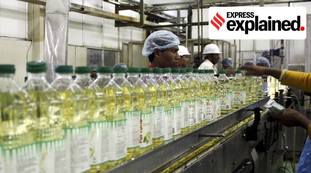 Employees fill plastic bottles with edible oil at an oil refinery plant in Mundra (Reuters Photo/File)