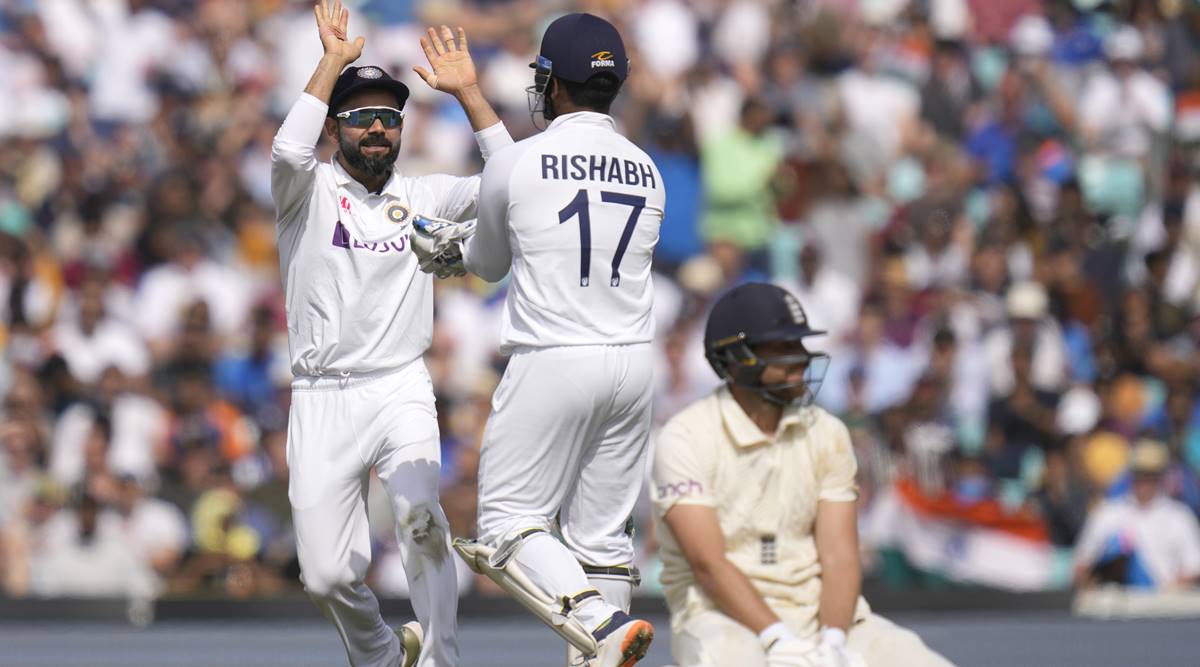 India's Virat Kohli, left, celebrates as England's Dawid Malan, right, is run out on day five of the fourth Test match at The Oval cricket ground in London, Monday, Sept. 6, 2021. (AP Photo/Kirsty Wigglesworth)