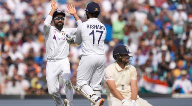 India's Virat Kohli, left, celebrates as England's Dawid Malan, right, is run out on day five of the fourth Test match at The Oval cricket ground in London, Monday, Sept. 6, 2021. (AP Photo/Kirsty Wigglesworth)
