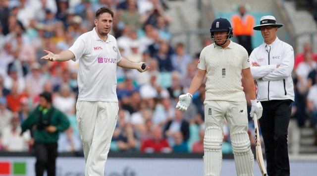 A man runs into England's Jonny Bairstow on the pitch and bowls a ball during the fourth Test against India. (Reuters)
