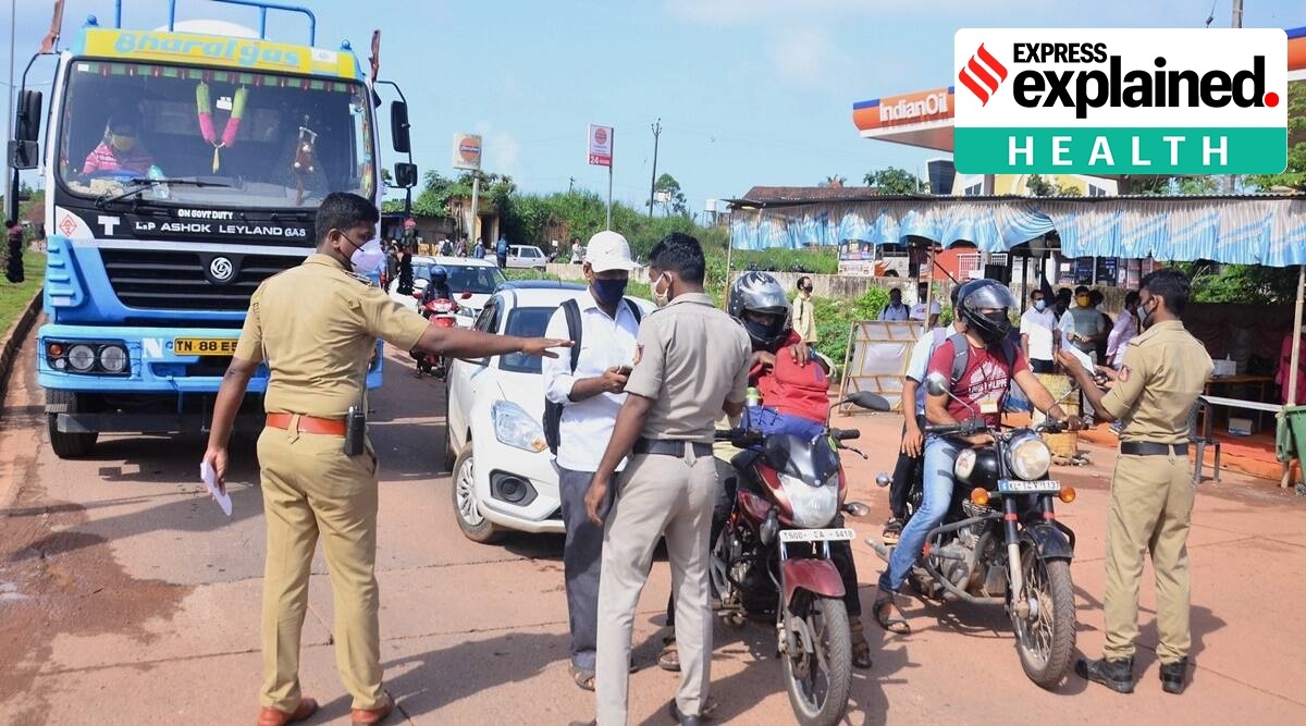 Police personnel check the Covid-19 test report of travellers at Talapady checkpost at Kerala-Karnataka border in Mangaluru (PTI Photo/File)
