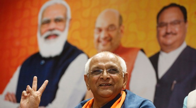 Bhupendra Patel shows a victory sign during a meeting at BJP Gujarat state office in Gandhinagar. (AP Photo: Ajit Solanki)