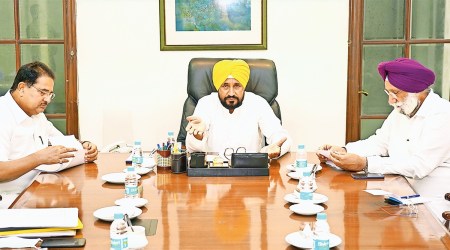 Channi with Dy CMs Soni and Randhawa in Chandigarh. (Photo: PTI)