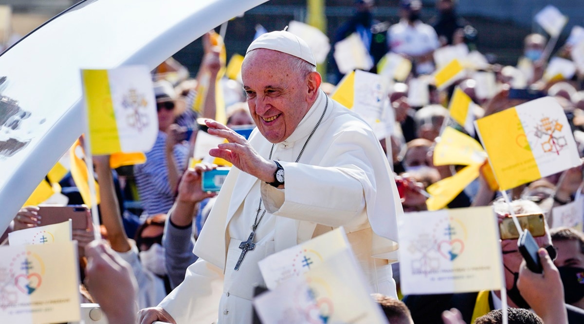 Pope Francis waves to faithful holding Vatican flags as he arrives on his pope-mobile to celebrate a Byzantine rite Mass at Mestska sportova hala Square, in Presov, Slovakia, Tuesday, Sept. 14, 2021. (AP)