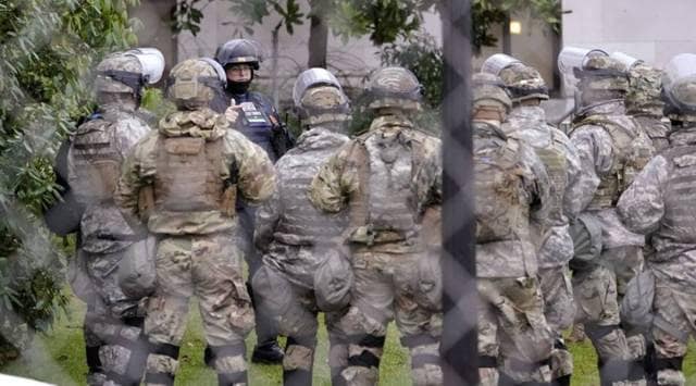 Members of the Washington National Guard inside a fence surrounding the Capitol. (AP Photo/File)