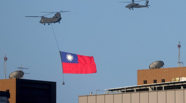 A Taiwan flag is carried across the sky during a national day rehearsal in Taipei, Taiwan on Oct 5, 2021. (Reuters)