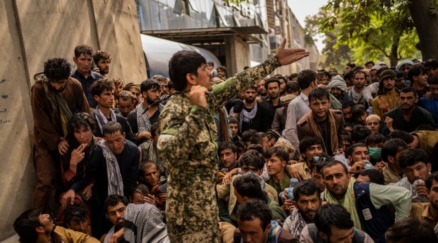 File photo of Afghans waiting in front of a bank as they try to withdraw money in Kabul. (AP)