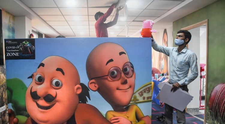 A man checks arrangements of the city's first children friendly vaccination centre, decorated with toys and posters, at Tilak Nagar in New Delhi, Friday, Oct. 22, 2021. (PTI Photo)