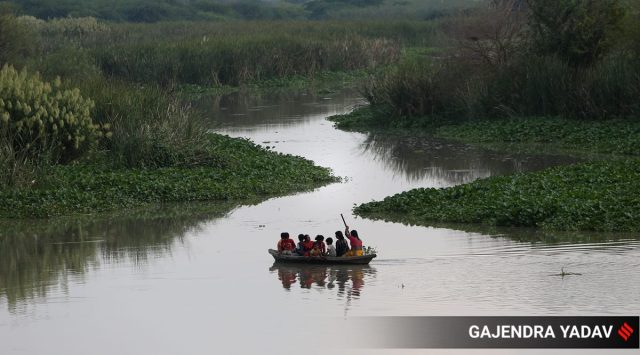 A family crosses the Yamuna on Tuesday. (Express Photo: Gajendra Yadav)