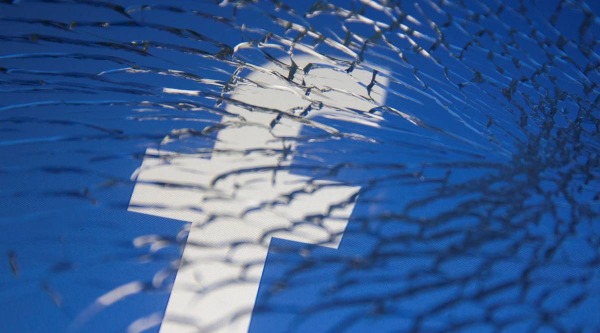 Facebook logo displayed through broken glass in this illustration taken October 4, 2021. REUTERS/Dado Ruvic/Illustration/File Photo