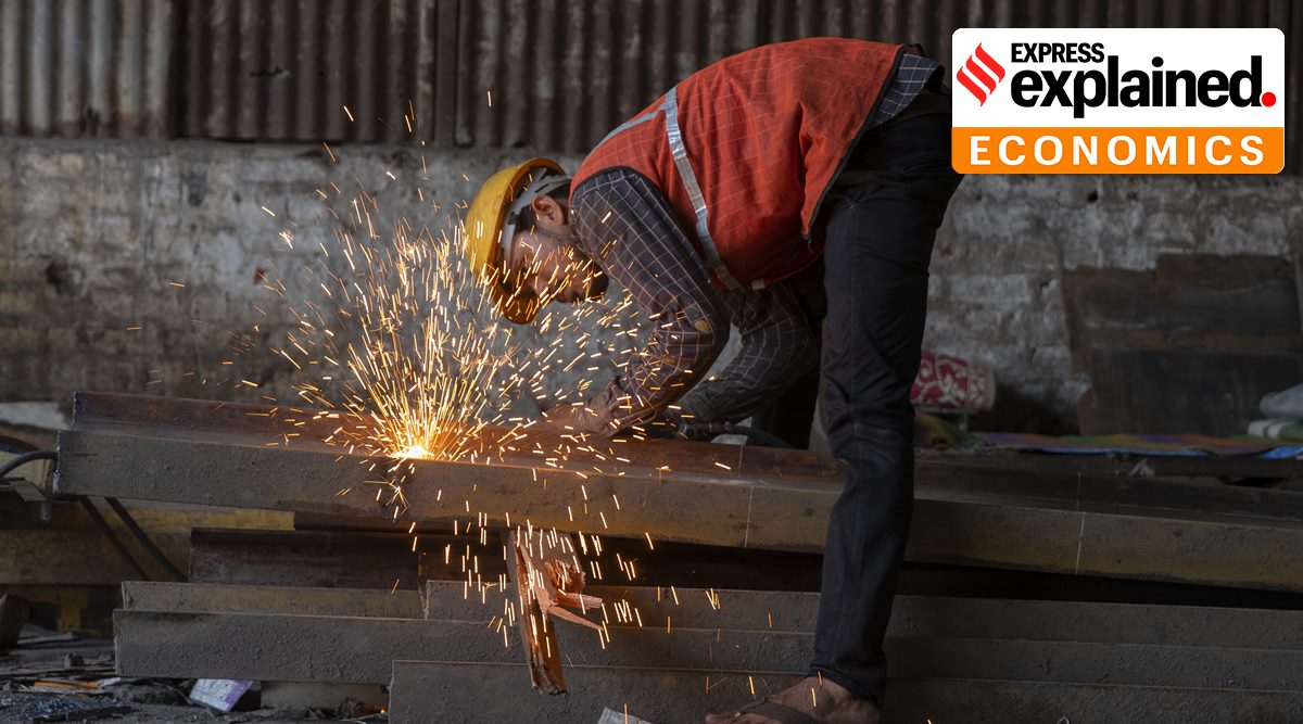 A worker welds an iron beam at a construction site near a railway station in Mumbai, India, Tuesday, Oct. 5, 2021. (AP Photo/Rafiq Maqbool)