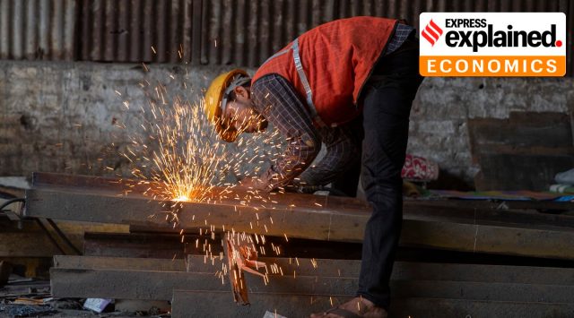 A worker welds an iron beam at a construction site near a railway station in Mumbai, India, Tuesday, Oct. 5, 2021. (AP Photo/Rafiq Maqbool)