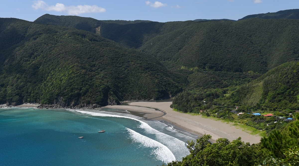 The mountain-fringed beach at the seaside village of Katoku, Japan, Sept. 21, 2021. (Noriko Hayashi/The New York Times)