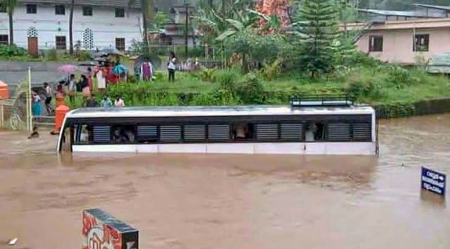 A bus gets stuck in a waterlogged area in Kottayam. (Photo: PTI)