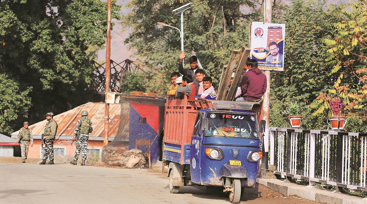 Non locals waving hands sitting in load-carrier going to their work place normally at  Bandipora.
(Express Photo by Shuaib Masoodi) 