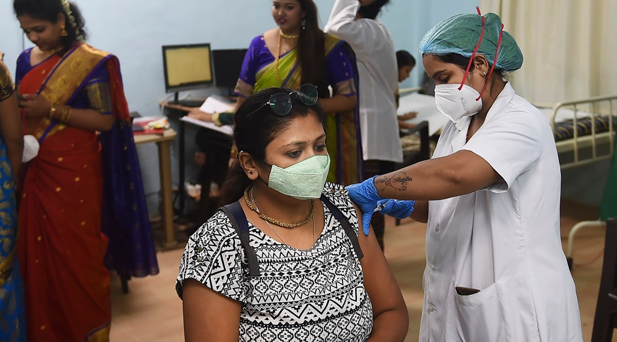 A health worker administers a dose of Covid-19 vaccine to a beneficiary in Mumbai. (PTI/File Photo)