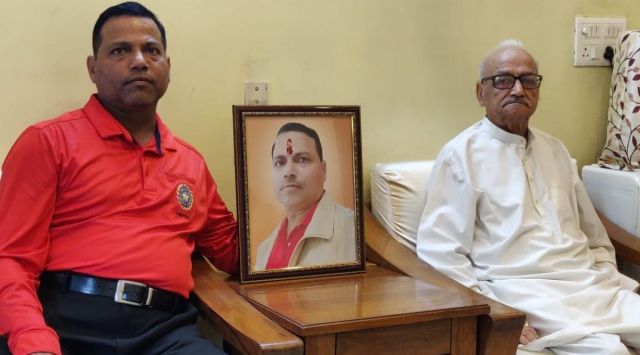 Veteran umpire SK Bansal (right) with son Amit Bansal at their home in East Delhi. Sumit Bansal passed away on October 10. (Express photo)
