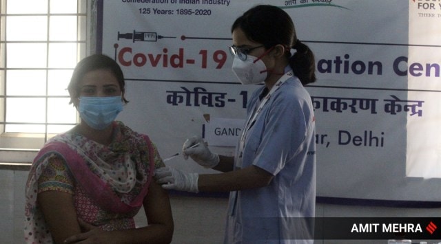 A beneficiary receiving a jab of Covid-19 vaccine at a vaccination centre. (Express photo by Amit Mehra)
