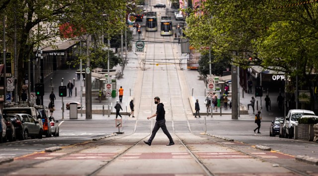 People cross Bourke Street in Melbourne, Thursday, Sept. 30, 2021. (Daniel Pockett/AAP Image via AP)