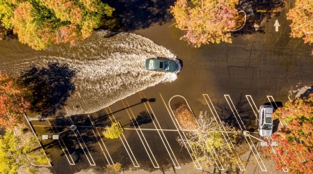 A car crosses a flooded parking lot in Oroville, California on Oct. 25, 2021. (AP)