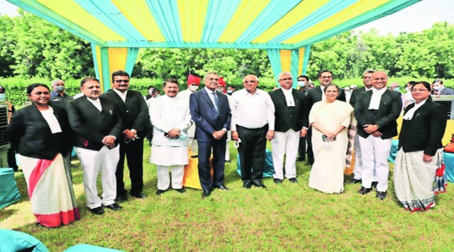 The judges with their colleagues and CM Bhupendra Patel after taking oath on Monday. Gujarat Information Department  (Express photo)