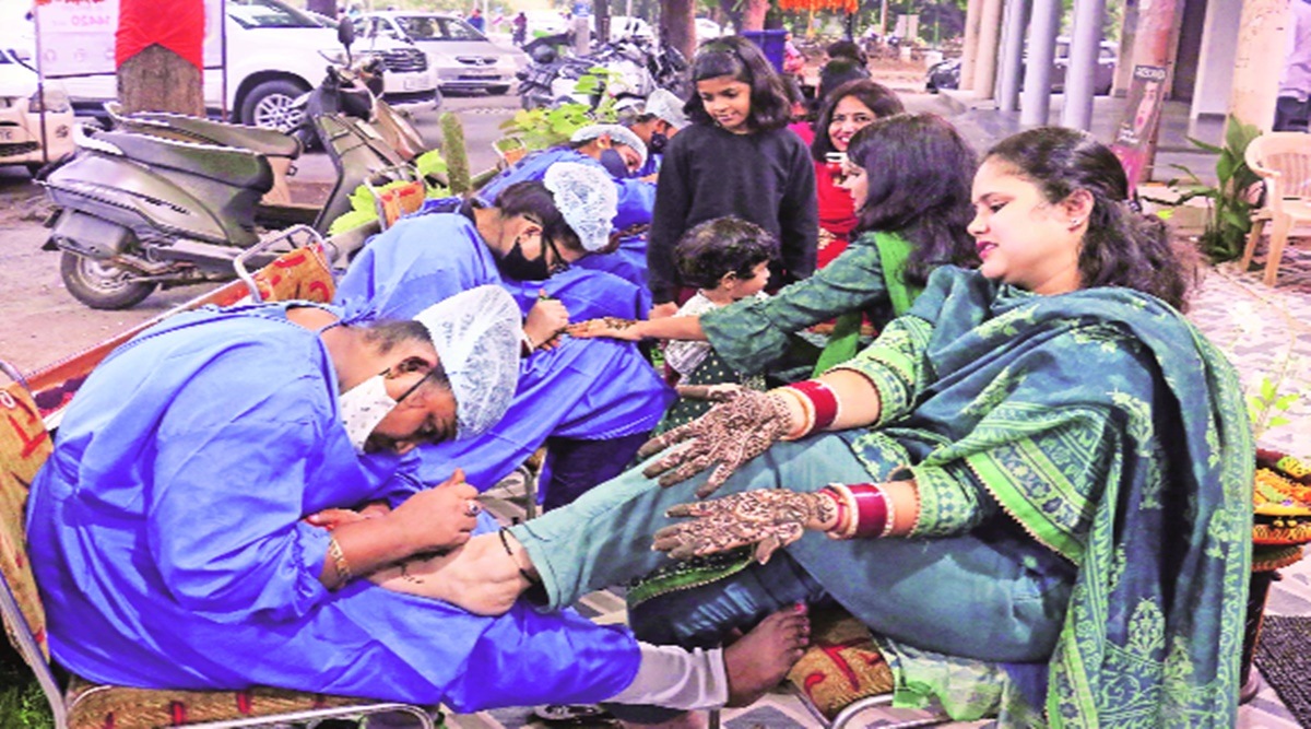 Artistes apply mehendi at a market in Chandigarh ahead of Karva Chauth  on Friday. Photo: Kamleshwar Singh