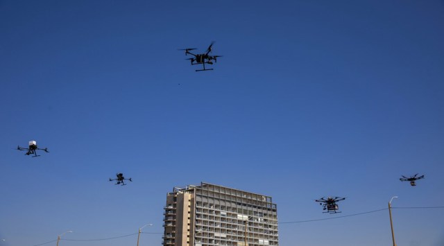 Drones carry goods as part of the National Drone Initiative test operation and demonstration for journalists, in Tel Aviv, Israel, Monday, Oct. 11, 2021. (AP Photo/Oded Balilty)