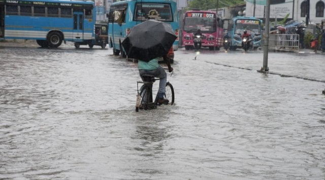 Man on a bicycle wades through the flooded roads in Kozhikode, Kerala. (Express Photo)